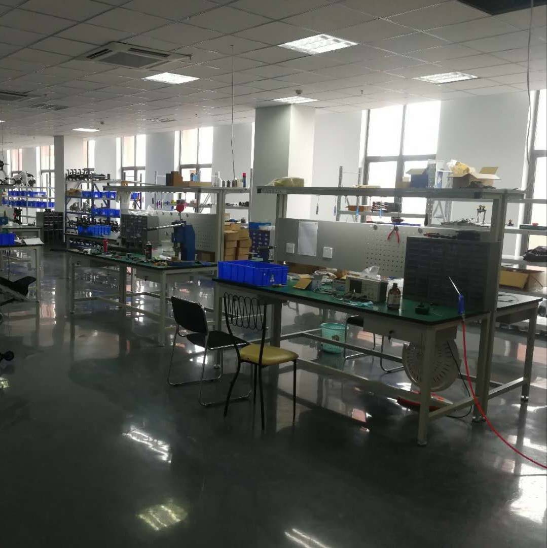 About 100Drone – Your Trusted Source for Drone Parts, Accessories, and DIY Resources 13 Clean precision assembly laboratory with organized tool stations and component bins