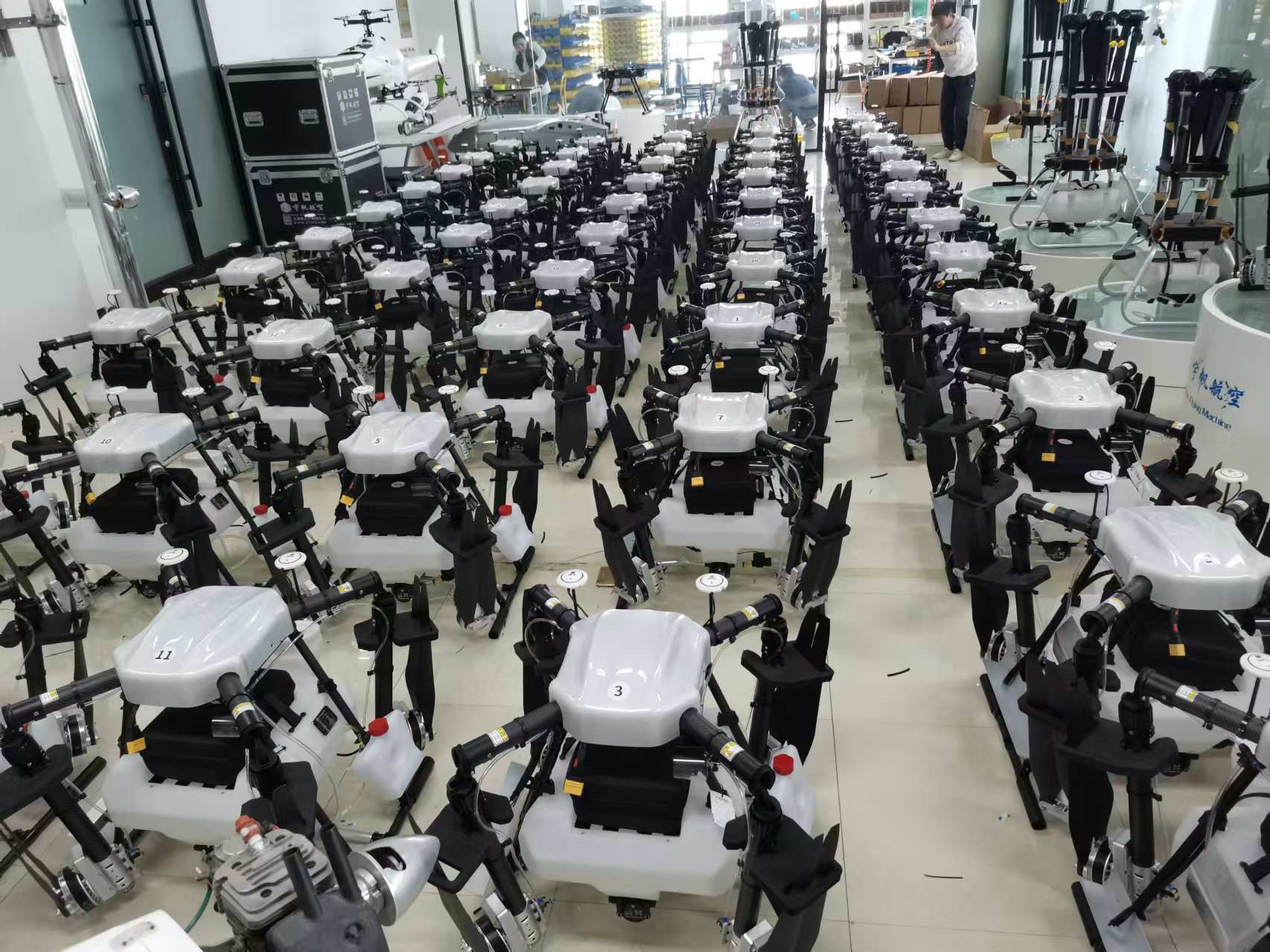 100Drone 6 Rows of industrial agricultural drones ready for deployment in a large workshop